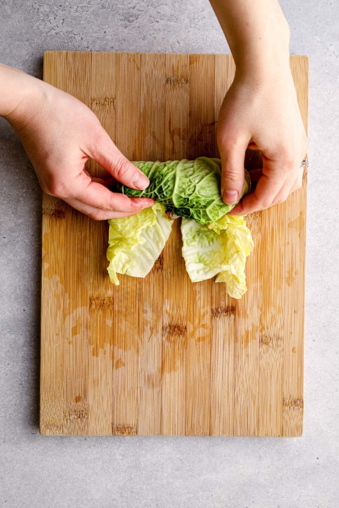 Rolling a cabbage leaf like a burrito.