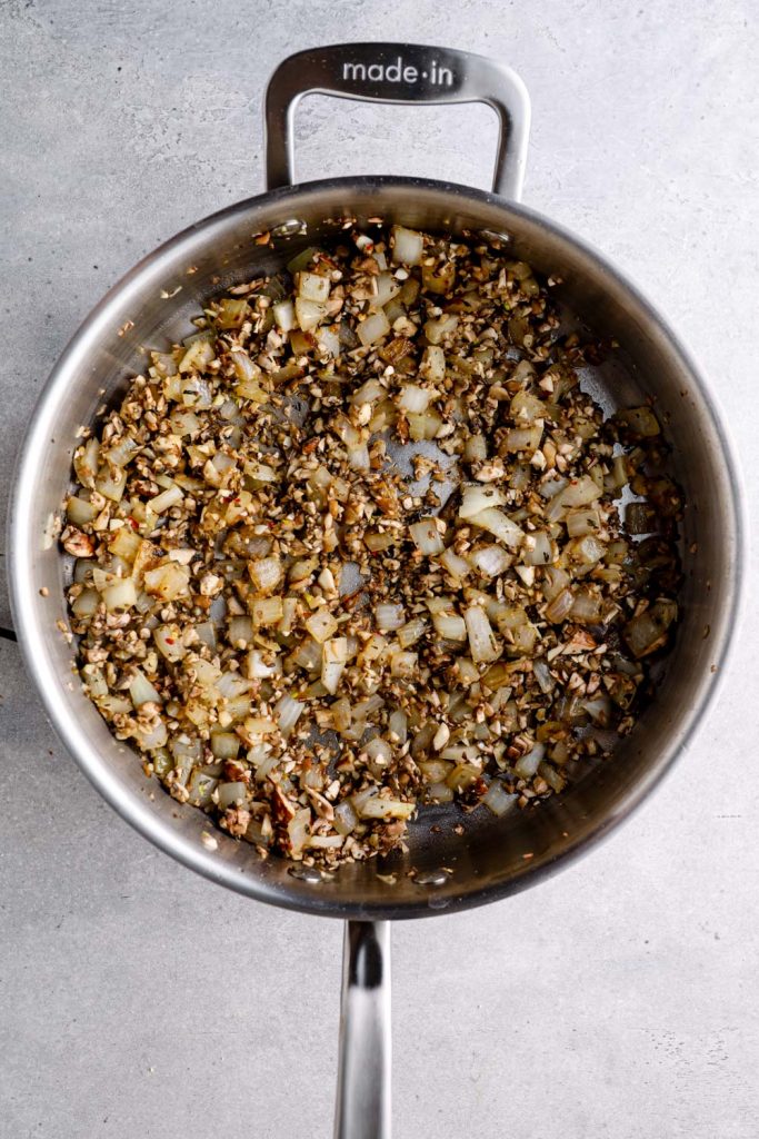 The wild rice and mushroom filling in a sauté pan.