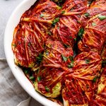 Baked vegetarian cabbage rolls with tomato sauce and parsley.