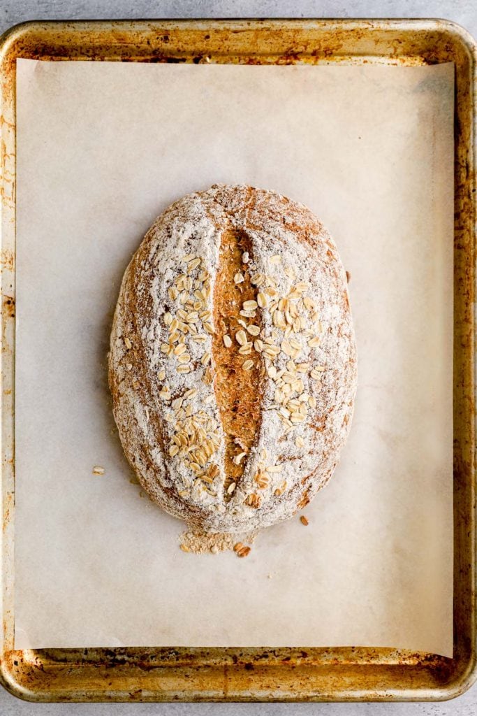 Baked gluten free honey oat bread on a sheet pan.