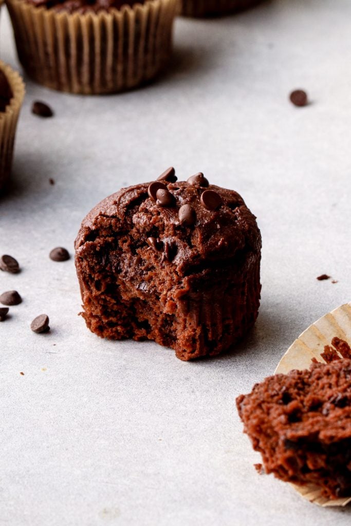 A chocolate sweet potato muffin with a bite out of it.