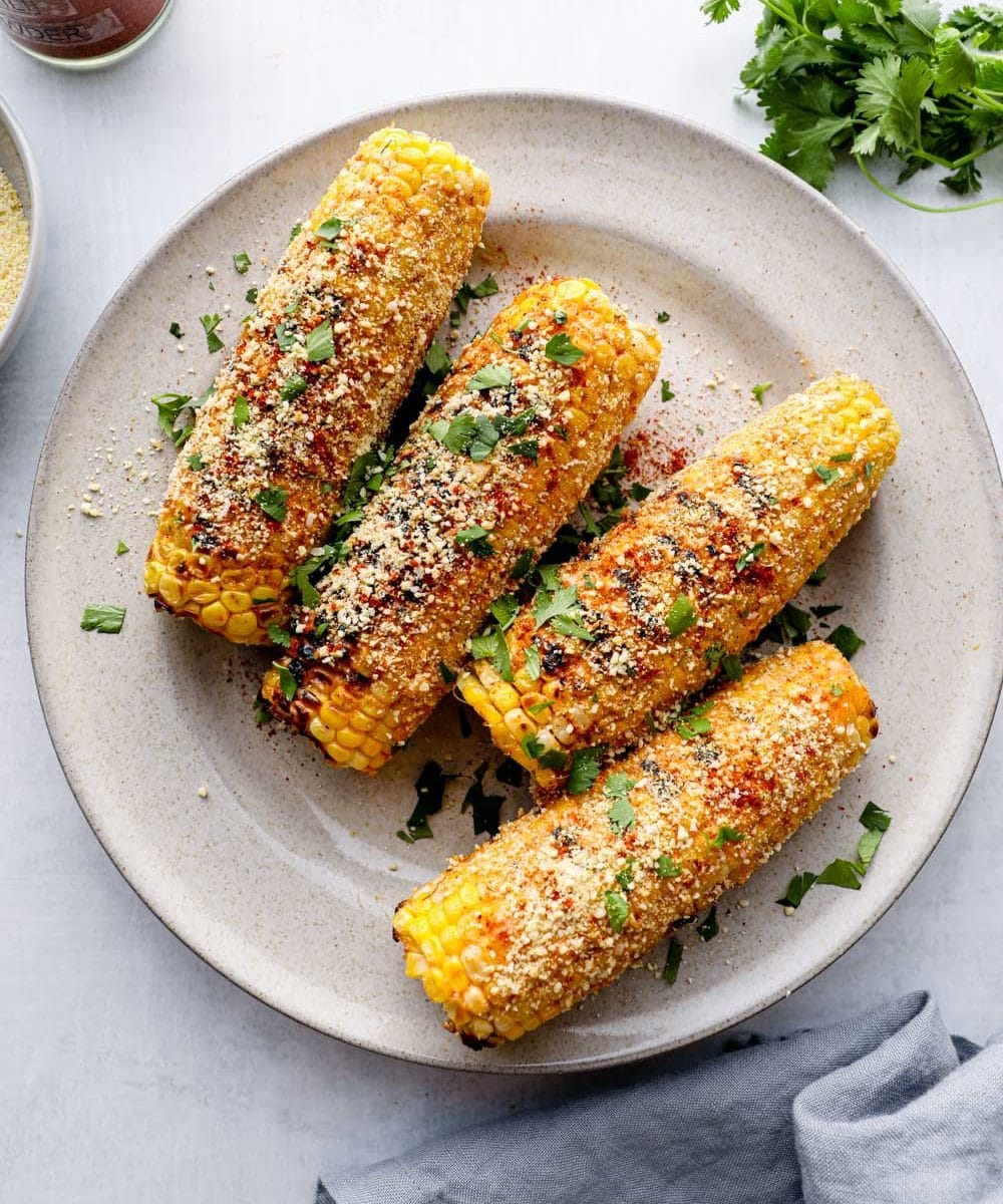 Elote with parmesan, chili powder, and cilantro.