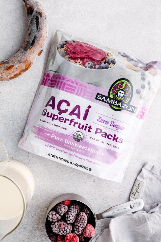 A frozen banana, almond milk, frozen berries, and acai puree packs.