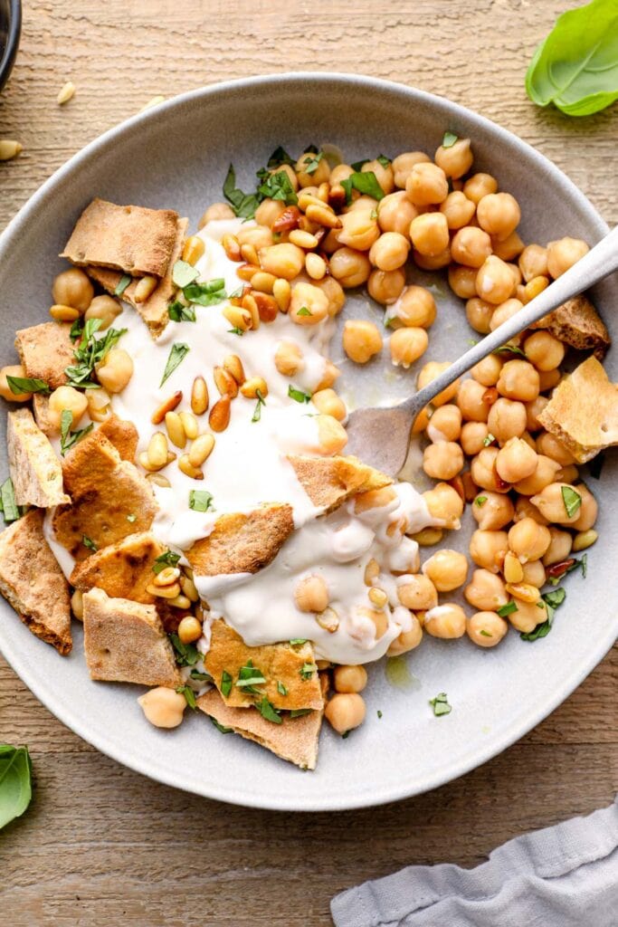 A bite of Lebanese fatteh with chickpeas and yogurt.