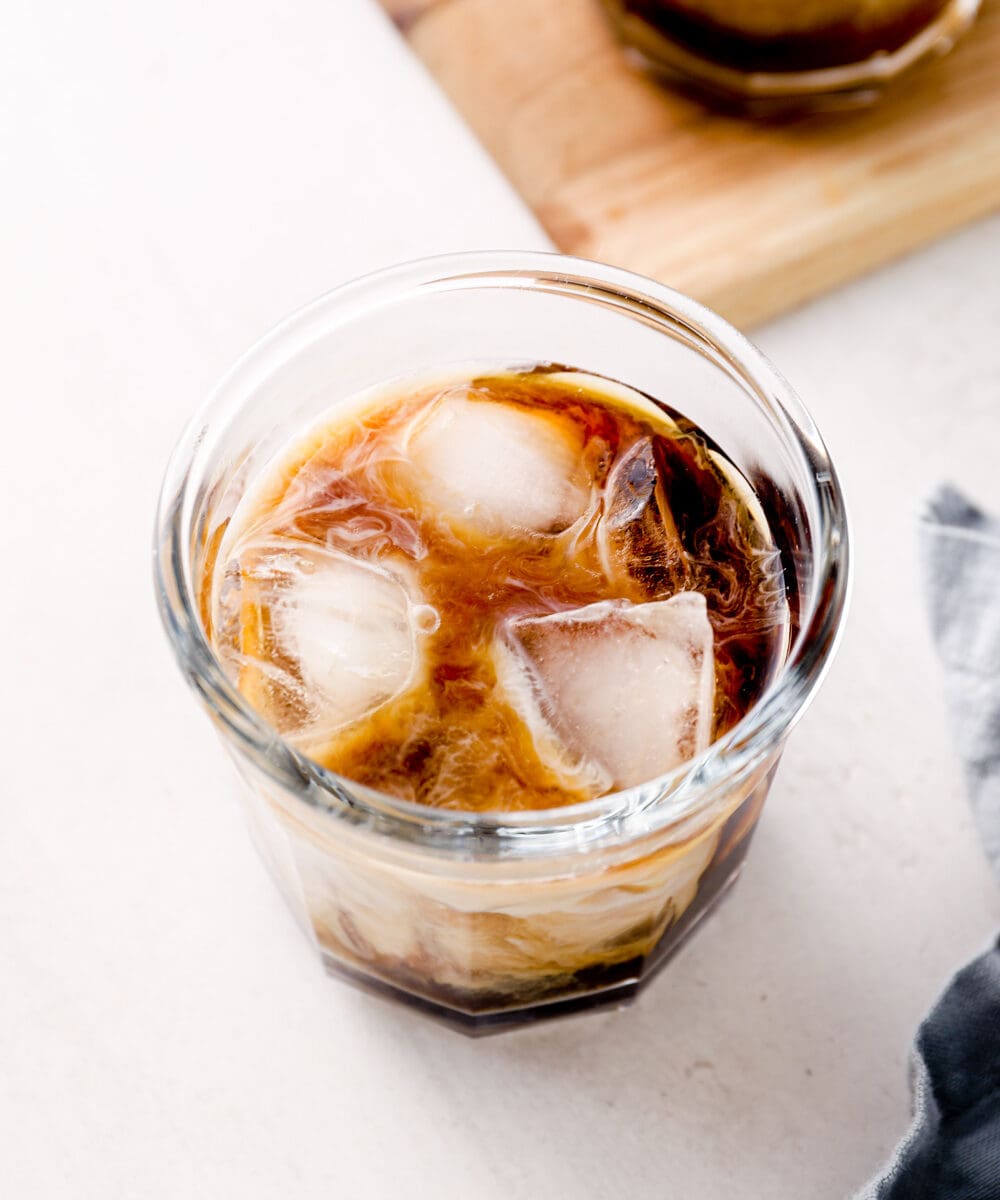 Honey almond milk cold brew in a glass over ice.