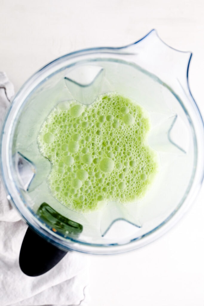 Matcha, honey, and milk blended in a blender.