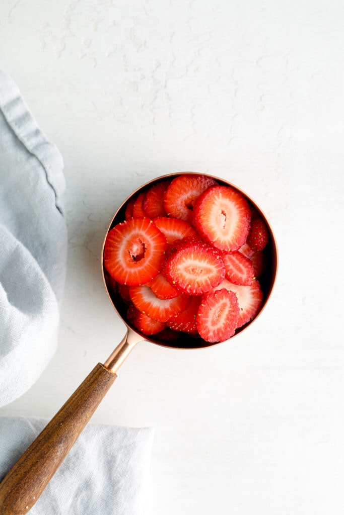 A cup of sliced strawberries.