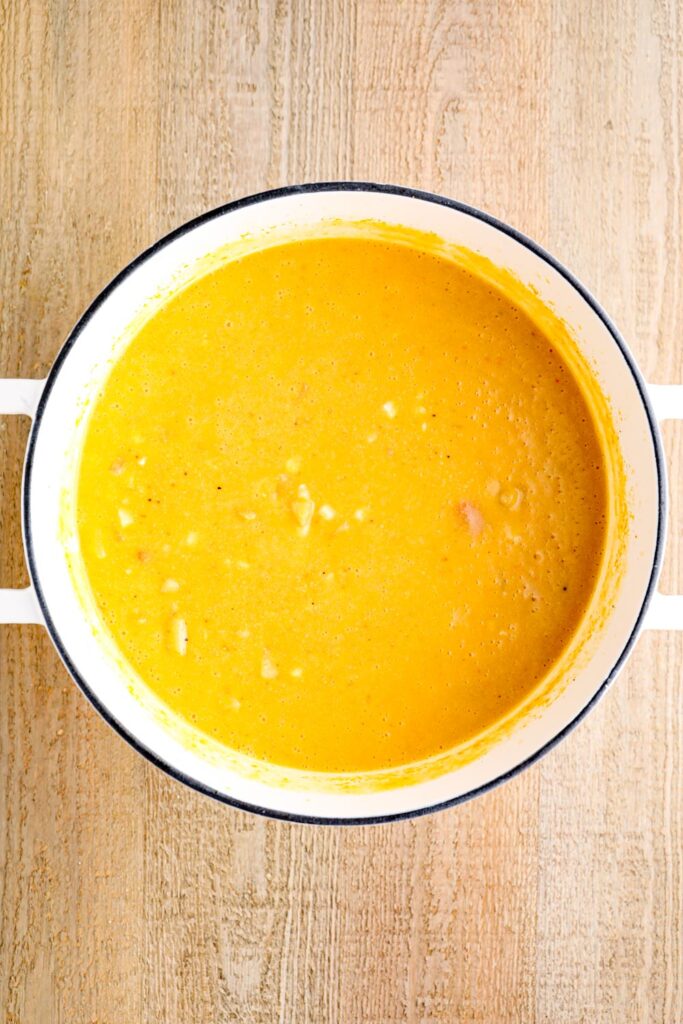 Blended vegan corn chowder in a white Dutch oven.