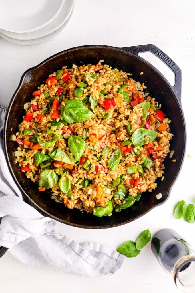 Thai fried rice in a pan topped with basil.