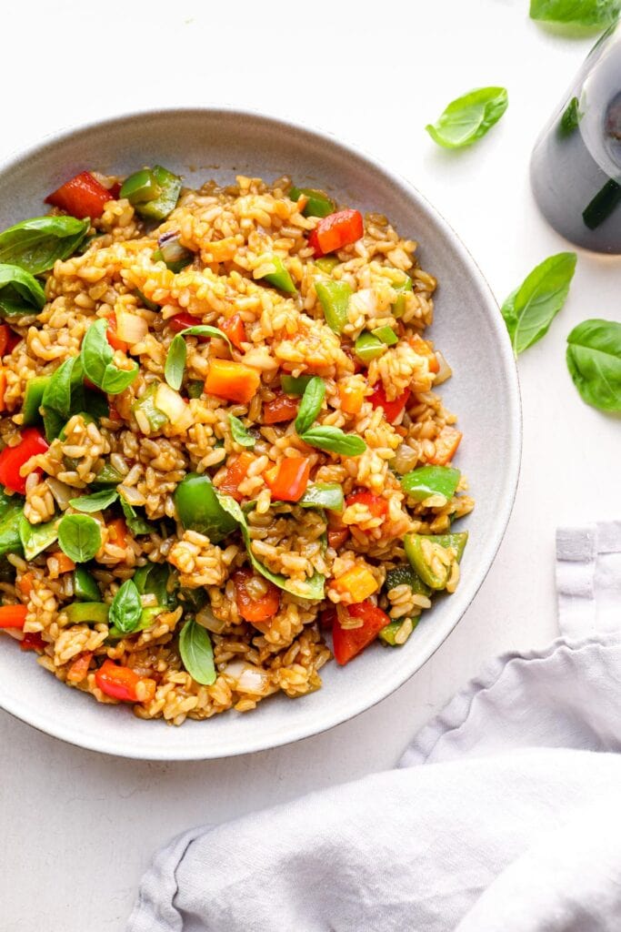 A closeup of Thai fried rice with lots of basil.