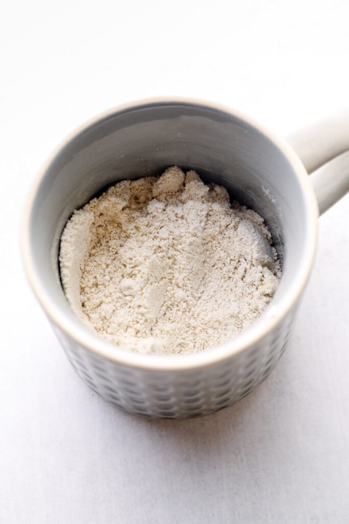 Dry ingredients mixed in a grey mug.
