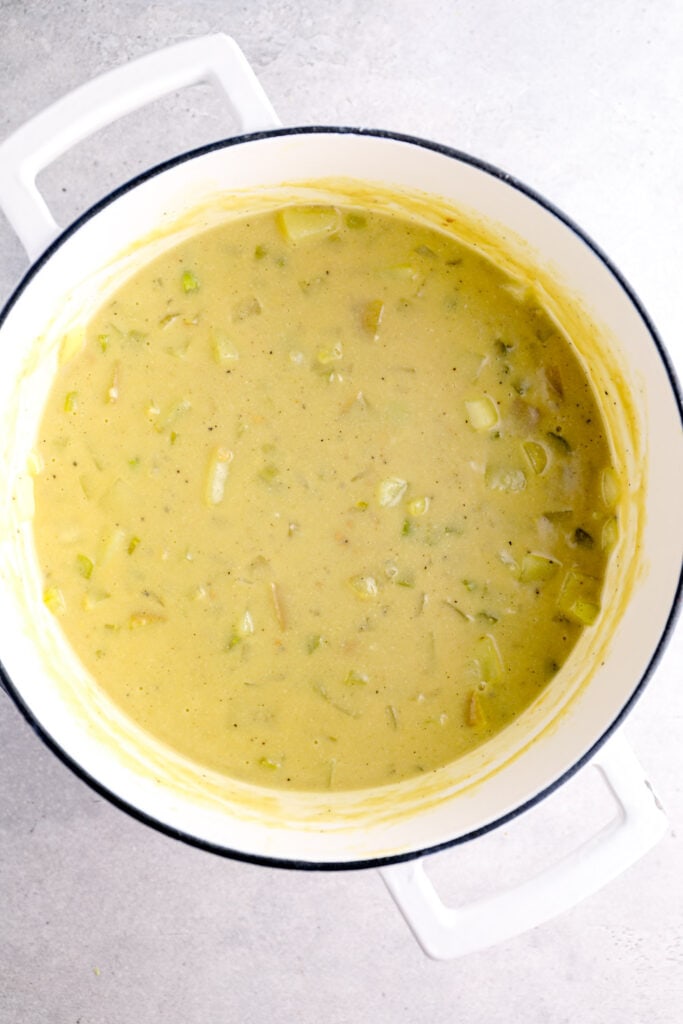 Finished potato soup in a white dutch oven.