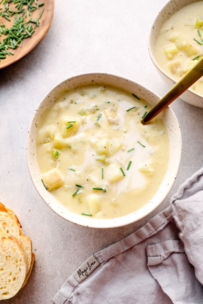 A bowl of gluten free potato soup with vegan cashew sour cream.