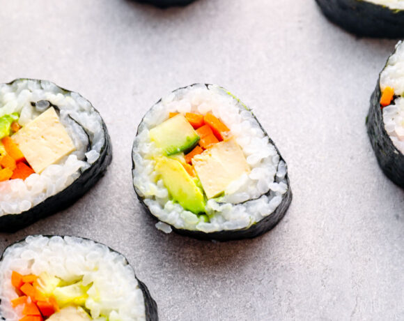 Tofu sushi rolls with avocado, carrot, and cucumber.